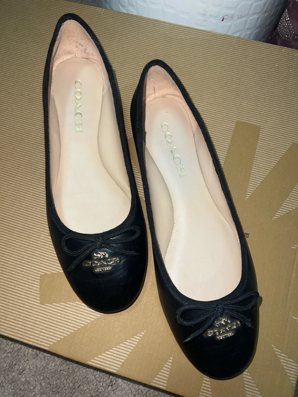 COACH Black Leather Ballet Flats with Bow and Logo Plaque